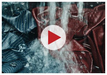 Play button over wet clothes and water